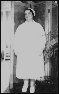 Rene Caisse standing and smiling in her nurse uniform in her Bracebridge Ontario Cancer Clinic 1930s